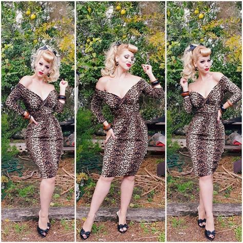 The Woman Is Posing In Her Leopard Print Dress