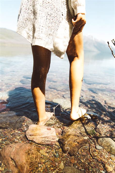 Womans Legs In Lake Near Glacier National Park Montana By Stocksy