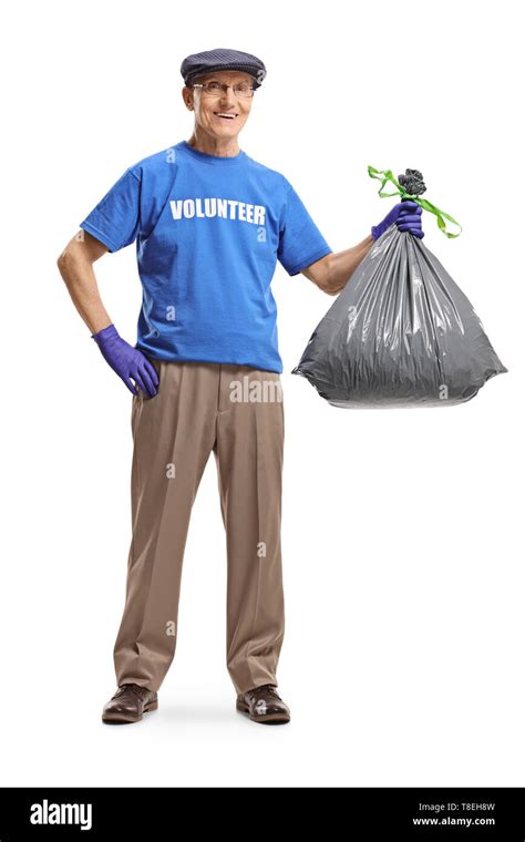 Full Length Portrait Of A Senior Male Volunteer Holding A Waste Bag