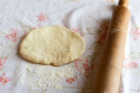 Raw Dough Resting On The Table With Wooden Rolling Pin Beside Stock