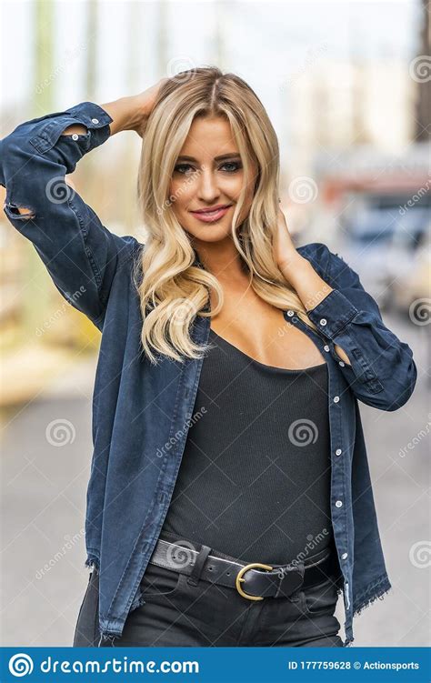 A Lovely Blonde Model Enjoys An Autumn Day Outdoors In A Small Town