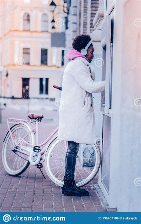 attentive female person standing near cash machine stock image image of street stylish 136467109