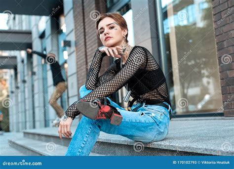 Urban Style Young Stylish Woman Sitting Outdoors Crossed Legs Looking Camera Sassy Stock Image