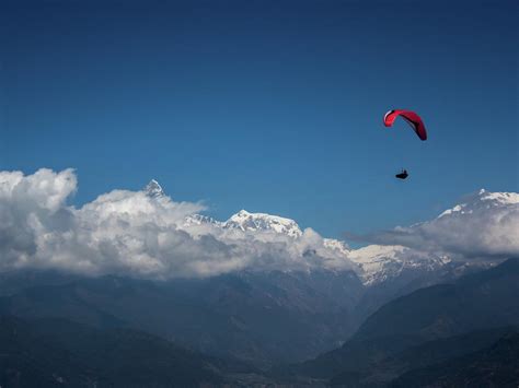 Paragliding Over Himalayas In Clouds Pokhara Nepal Photograph By Cavan