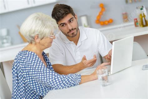Man Teaching His Granny To Use The Laptop Photo Background And Picture