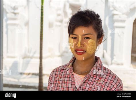 Young Burmese Woman With Leaves Painted On Her Cheeks With Thanaka