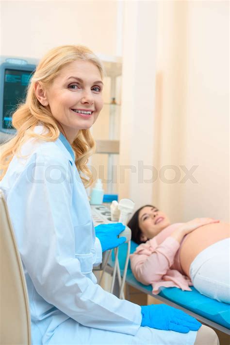 Obstetrician Gynecologist And Pregnant Woman In Ultrasound Examination Office Stock Image
