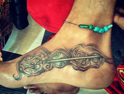 A simple diamond design is rendered on the wearer's wrist in black ink in this tattoo. Trishula tattoo #artist jay kasol | Connected learning, Tattoos, Artist