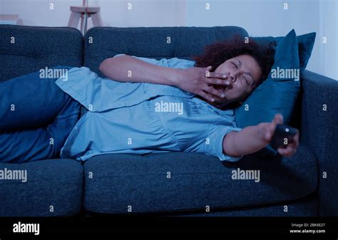 Black Tired Woman Relaxing At Home Watching Tv Stock Photo Alamy
