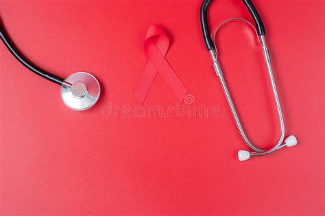 Red Ribbon With Stethoscope For Supporting People Living And Illness