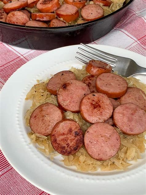 Stir sauerkraut and cabbage into the pork drippings, bring to a simmer, and cook until cabbage is very tender, about 3 mix kielbasa into the cabbage and kraut; Kielbasa and Sauerkraut - Plowing Through Life