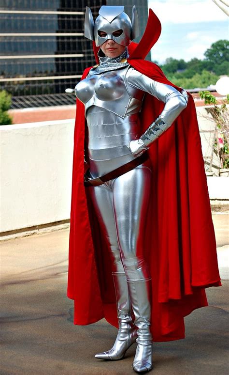 A Woman Dressed In Silver And Red Is Standing With Her Hands On Her