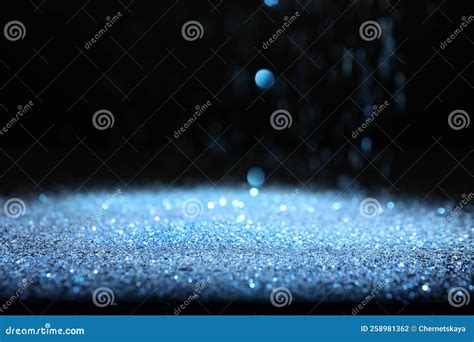 Shiny Blue Glitter Falling Down On Black Background Bokeh Effect Stock