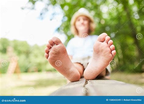 Boy Sits Barefoot On A Park Bench Stock Image Image Of Kids Vacation