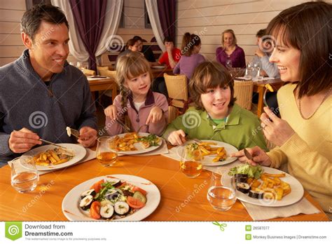 Family Eating Lunch Together In Restaurant Stock Image - Image: 26587077