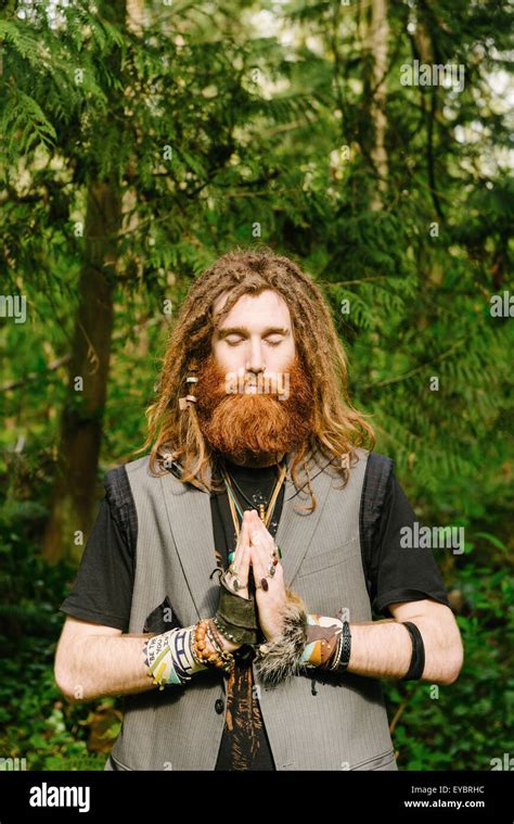 A Hippy Man Meditating In The Forest Stock Photo Royalty Free Image
