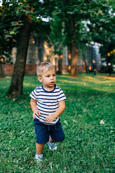 Cute Boy Walking In The Park By Stocksy Contributor Mosuno Stocksy