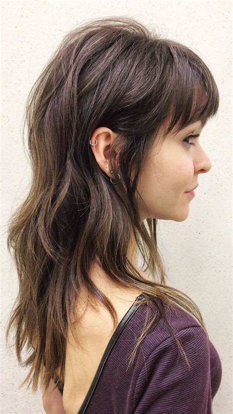 The burgundy bangs are the additional spice that blends well with your. Long layered wavy brunette shag haircut with wispy rounded ...