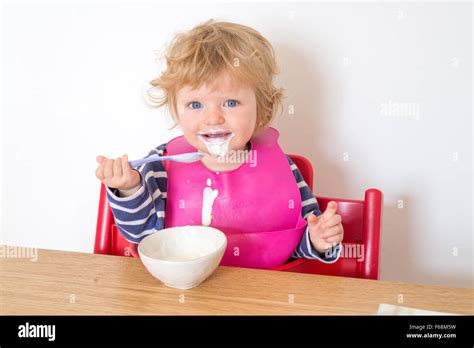 One Year Old Baby Eating Yoghurt Messily England Uk Stock Photo Alamy