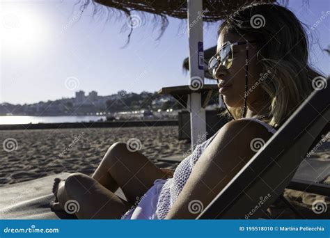 Beautiful Vietnamese Asian Woman Relaxing On The Beach Bed Facing The