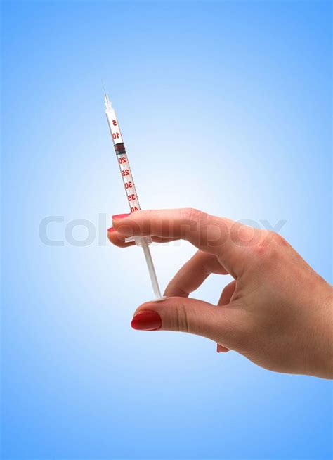 Hand Holding Syringe Isolated On The White Stock Image Colourbox
