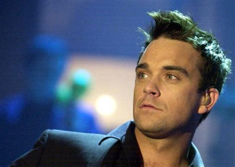 Robbie Williams Performs With Naked Models