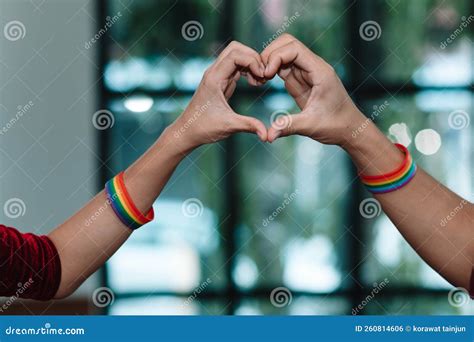 The Lgbt Couple Or Lgbtqia Couple Wear Rainbow Colored Wristbands On Their Wrists And Hold