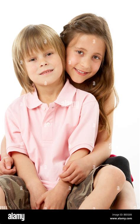 Two Children Sitting With Each Other In Studio Stock Photo Alamy