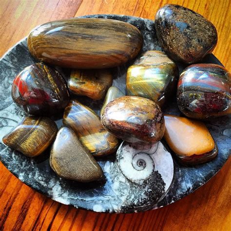 A Plate Filled With Lots Of Different Types Of Rocks On Top Of A Wooden