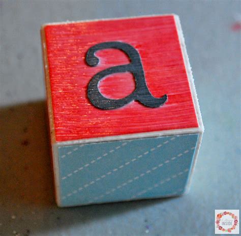 Arrange alphabet blocks face up to spell out the word or name. DIY Alphabet Blocks | Mabey She Made It