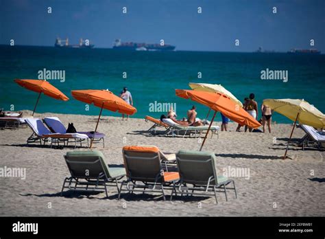 Group Of People Sunbathing On The Beach Miami Florida Usa Stock
