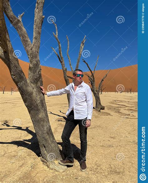 Man In Deadvlei Valley Dried Lake In Desert Of Namibia Sossusvlei