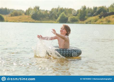 Cute Little Boy Having Fun Playing With Inflatable Swim Ring On Hot