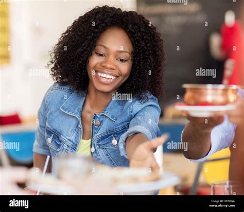 Happy Woman With Friends Eating At Restaurant Stock Photo Alamy