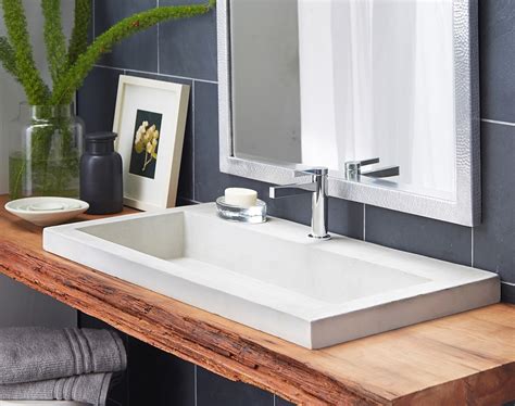 This particular wooden basin made in stone rain wood blends into the warm environment with its. Eco-Conscious, Artisan-Crafted Sinks Sparkle With Contemporary Class