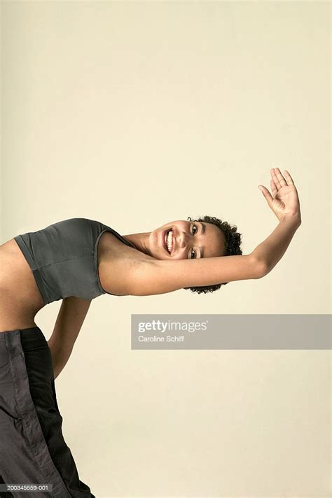 Teenage Girl Bending Backwards Smiling Side View High Res Stock Photo
