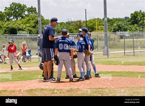 Boys Youth Baseball Team Coach Talking With His Teams Players Stock
