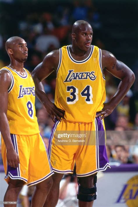 Shaquille Oneal And Kobe Bryant Of The Los Angeles Lakers Looks On