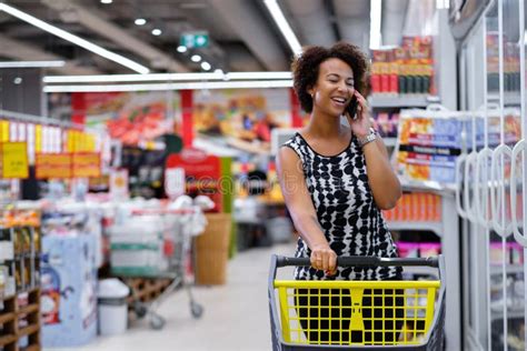 Pretty Black Woman Choosing Goods In A Grocery Store Stock Image