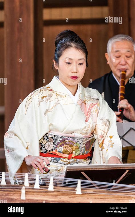 kyoto yasaka shinto shrine noh performance mature japanese woman in kimono kneeling playing