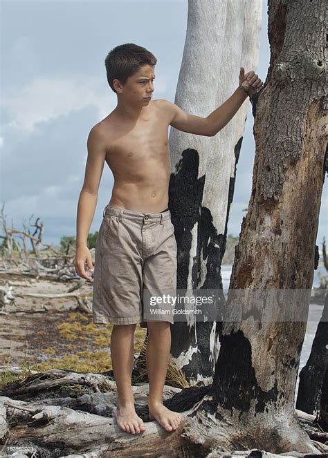 Boy Exploring Island On Deserted Beach Photo Getty Images