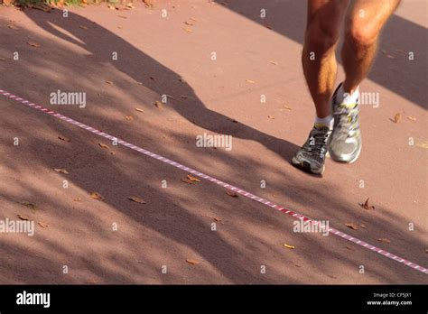 A Male Runner Crossing The Finish Line Stock Photo Alamy