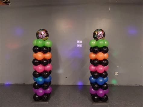 80's theme balloon columns using black and neon balloons. Please visit