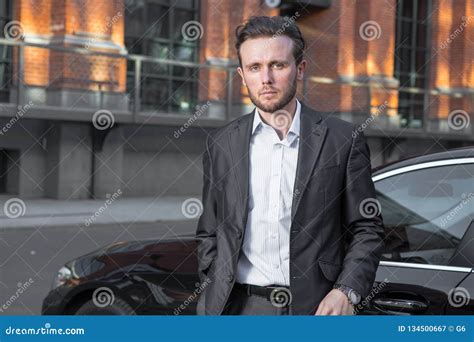 Attractive Successful Young Businessman In A Business Suit Near Stock