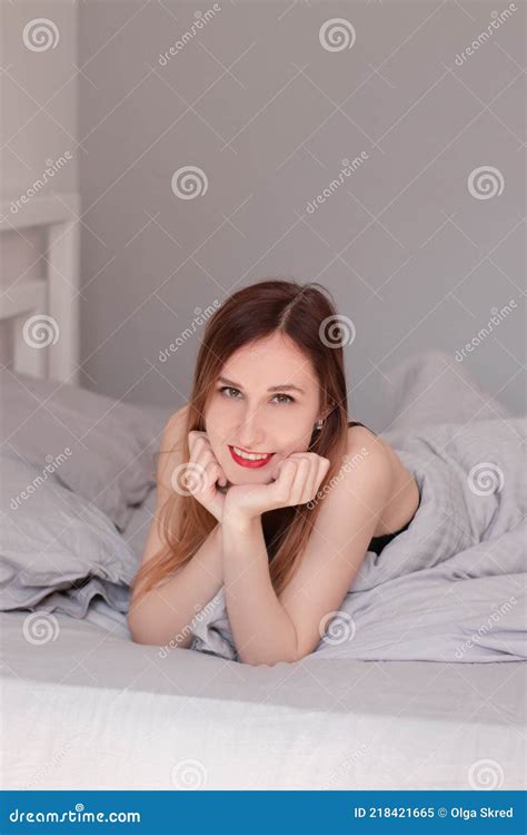 pretty redhead woman in black lace lingerie on bed with grey sheets stock image image of
