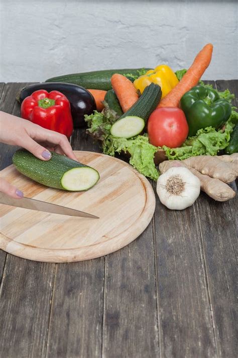 Fresh Vegetables On Chopping Board And Dark Table Zucchini Cut Into