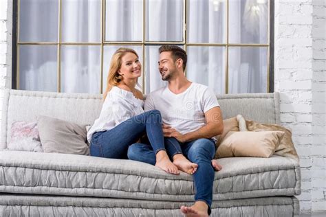 Young Couple Cuddling On The Sofa Stock Image Image Of Couple