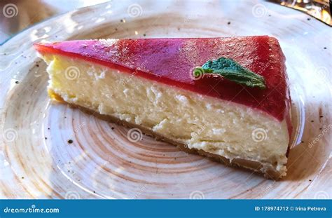Cold Cheesecake With Cherry Jelly With Green Mint Leaf Stock Photo