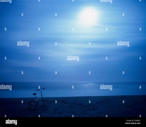 Bicycle On Beach At Night Stock Photo Alamy