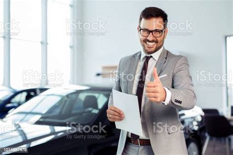 Salesperson At Car Dealership Selling Vehicles Stock Photo Download